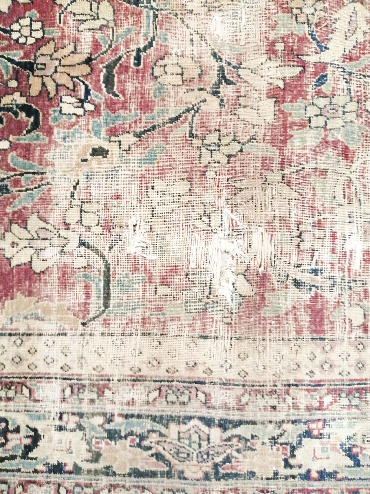 An antique Kashan blue ground carpet (worn and holed) 410 x 300cm